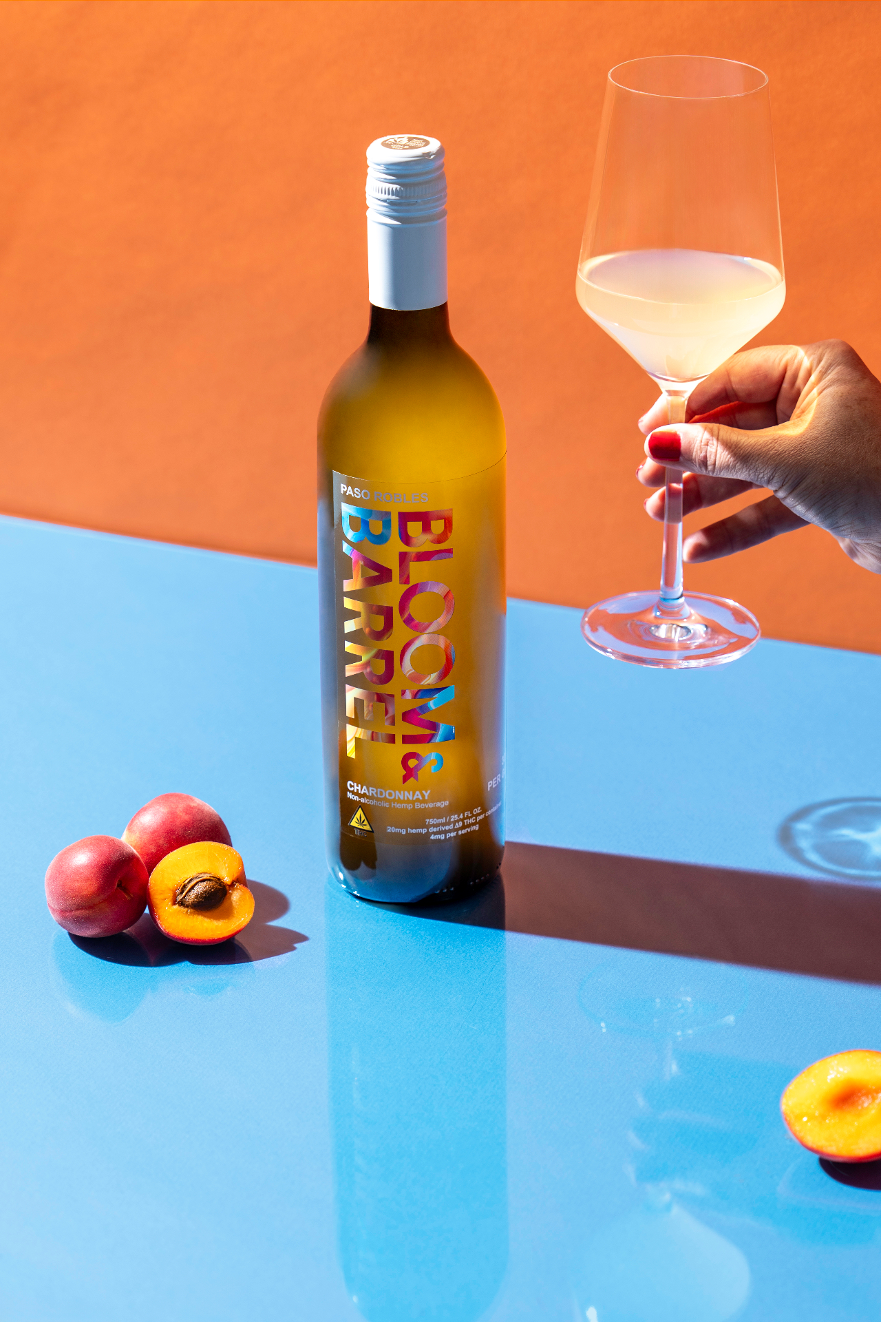 Bloom & Barrel Chardonnay bottle with wine glass and peaches
